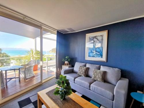 a living room with a couch and a view of the ocean at The Sandridge Motel in Lorne
