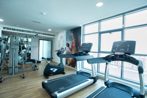 a gym with treadmills and ellipticals in a building at City Avenue Al Reqqa Hotel in Dubai