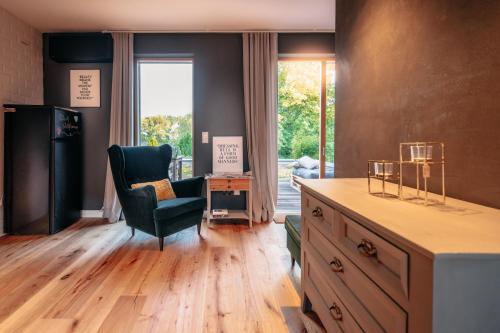 a living room with a desk and a chair and a window at Designapartment in Lutherstadt Wittenberg