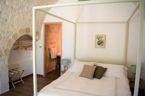 a bedroom with a white bed with a glass canopy at TRULIVO in Monopoli