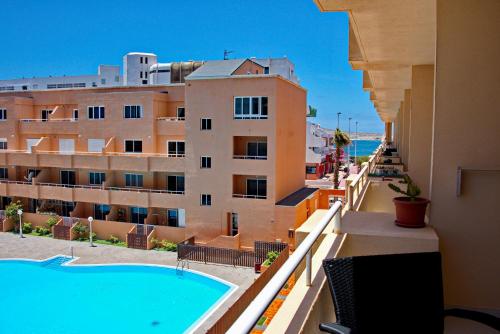 a view from the balcony of a hotel with a swimming pool at MEDANO4YOU Cabezo at Marineda in El Médano