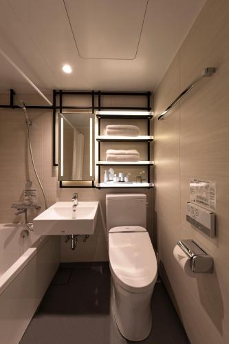 a bathroom with a white toilet and a sink at Yukari no Mori in Fujikawaguchiko
