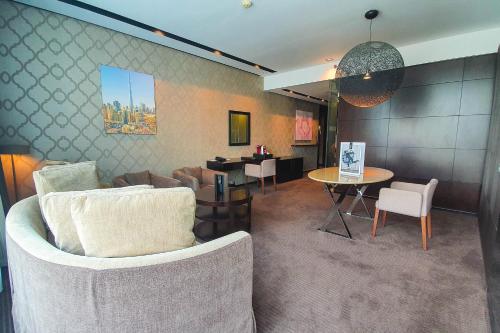 a living room with a couch and a table at The Canvas Dubai - MGallery Hotel Collection in Dubai