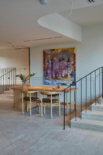 a dining room with a table and a painting on the wall at RUNO Hotel Porvoo in Porvoo