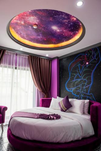 a bedroom with a star system painted on the ceiling at Lavie Hotel in Hanoi