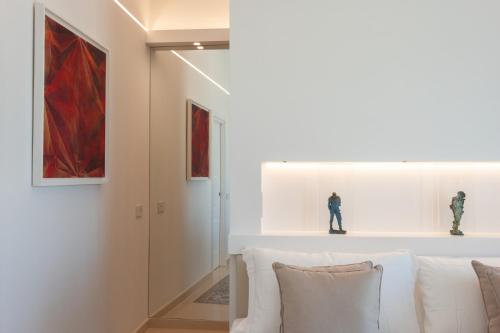 a living room with a white couch and a red painting at Sopramonte Exclusive Rooms in Capri