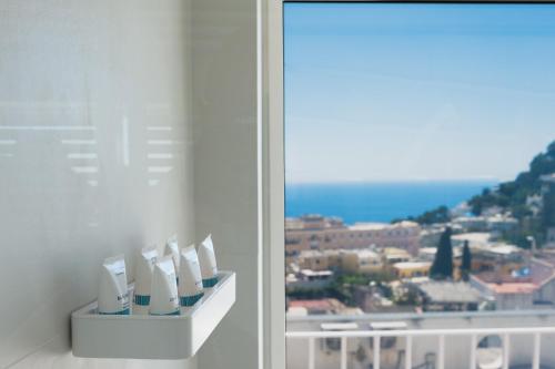 a room with a window with a view of a city at Sopramonte Exclusive Rooms in Capri