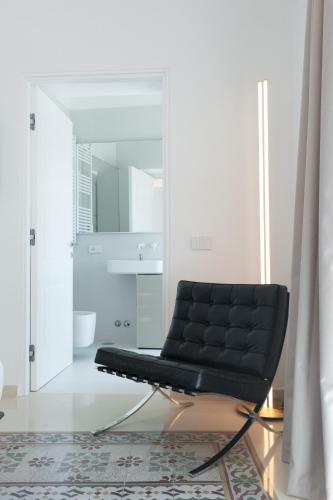 a black leather chair sitting in a room at Sopramonte Exclusive Rooms in Capri