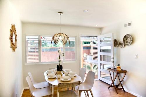 a dining room with a white table and chairs at Private Seattle Getaway Home Near Lake Washington! in Seattle
