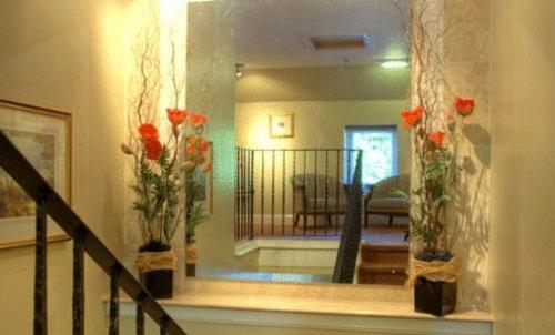 a hallway with two vases with red flowers in them at Aaron Lodge in Edinburgh