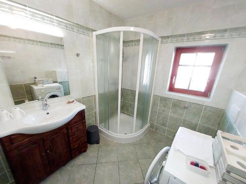 a bathroom with a shower and a sink at Villa Nebina in Rateče