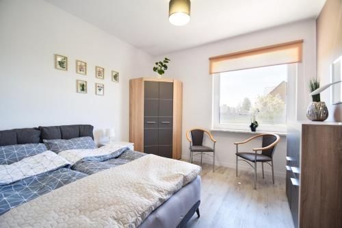 Ένα ή περισσότερα κρεβάτια σε δωμάτιο στο Willa Prestige Sianożęty