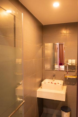 a bathroom with a sink and a mirror at Lavie Hotel in Hanoi