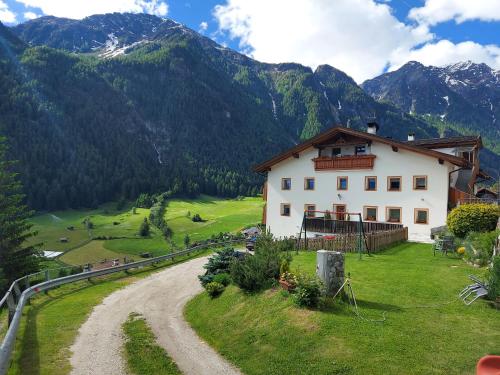 una casa su una collina vicino a una strada sterrata di Ferienhof Mairulrich a Martello