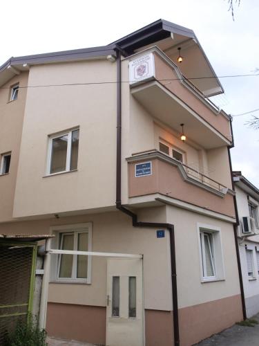 a building with a balcony on the side of it at Bogdanoski Studios & Guest Rooms in Ohrid