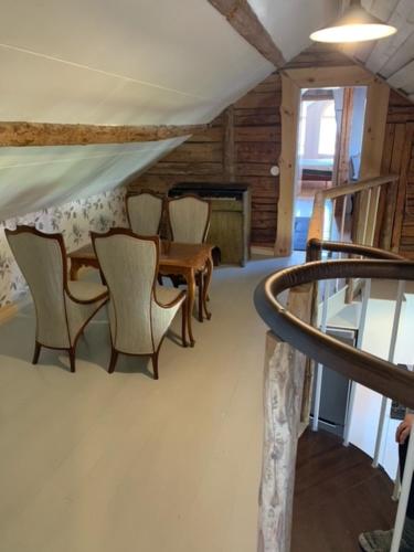 a room with chairs and a table in a room with at Hultets gård in Lerdala