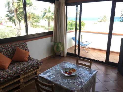 a living room with a couch and a table at Panorama sul Mare in Noto Marina