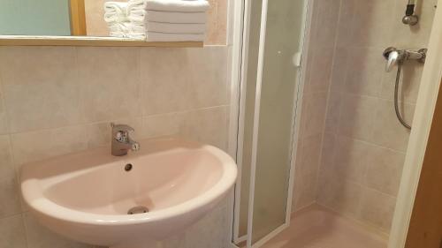 a white sink in a bathroom with a shower at Hotel La Renaissance in Cherbourg en Cotentin
