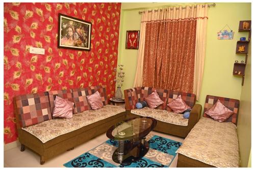 a living room with two couches and a table at SOHANAs Homestays- 2 BHK Luxury Apartment near Jaipur International Airport in Jaipur
