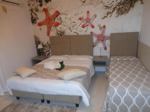 a bedroom with two beds and stars on the wall at Oasi Verde in Lido di Jesolo