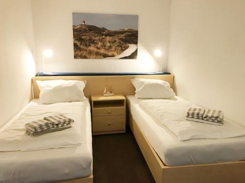 Postel nebo postele na pokoji v ubytování Haus Frisia Bungalow Frisia 1