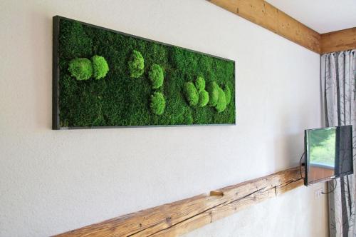 a picture hanging on a wall with moss at Alpengasthof Krische in Murau