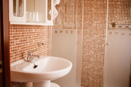 a bathroom with a sink and a shower at Hostal la Campana in Motril