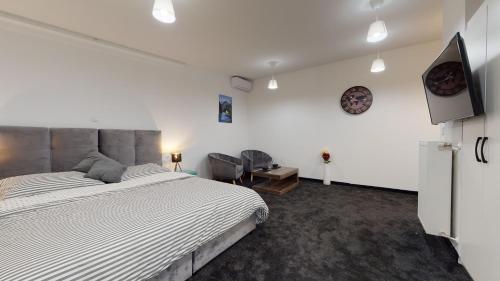 a bedroom with a bed and a flat screen tv at WooW Apartments in Velika Gorica