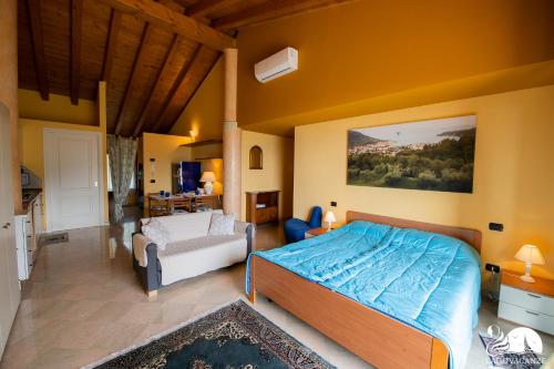 a bedroom with a bed and a couch in it at Feeling House in Salò