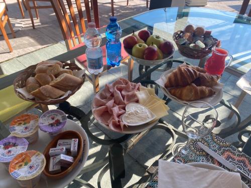 a table with plates of food on a glass table at Bellagio Bed & Breakfast in Bellagio