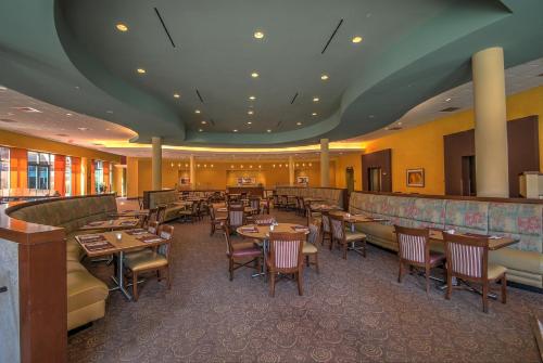a restaurant with tables and chairs and a bar at Wellsworth Hotel in Southbridge