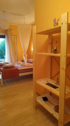 a bedroom with a bunk bed and a room with a bed at Spiti Mitsis in Arillas