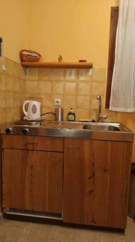 a kitchen with a sink and a counter top at Spiti Mitsis in Arillas