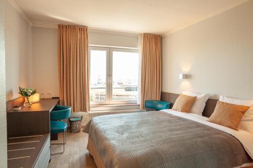 Ein Bett oder Betten in einem Zimmer der Unterkunft Hotel Monaco Zeebrugge Beach by Rikas Hotels