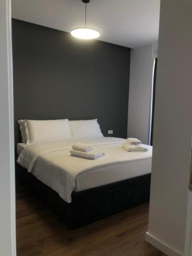 a bedroom with a bed with two towels on it at Grand Hotel Pogradec in Pogradec