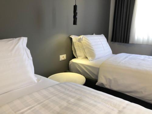 a hotel room with two beds and a table at Grand Hotel Pogradec in Pogradec