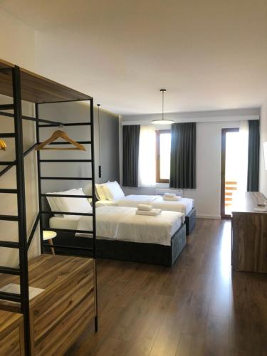 a bedroom with a bed and a bunk bed at Grand Hotel Pogradec in Pogradec