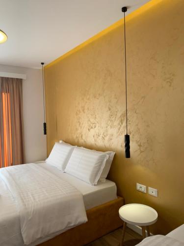 a hotel room with two beds and a table at Grand Hotel Pogradec in Pogradec