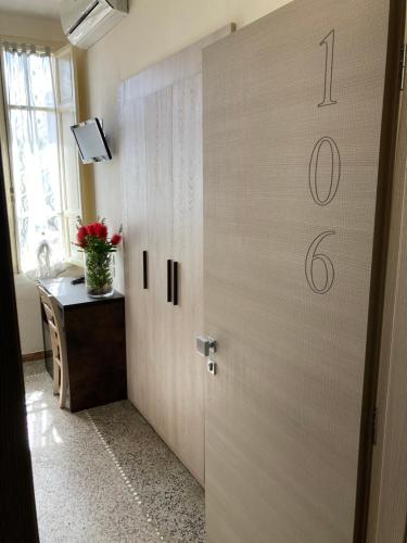 a door with a clock on it in a room at Hotel Verdesolemare in Marina di Pietrasanta
