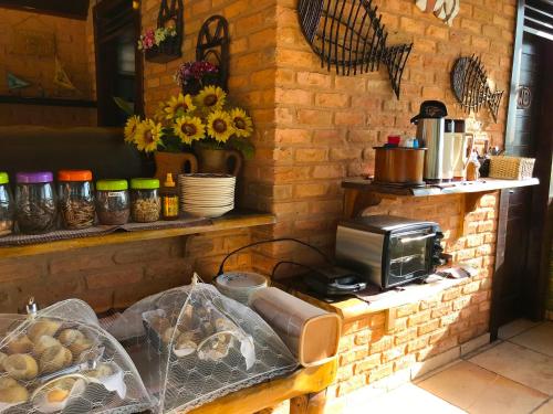 a kitchen with a counter with a toaster and some bread at Hotel Pousada Beleza das Ondas in Cumbuco