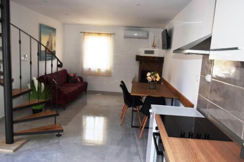a living room with a couch and a table at Two-Bedroom House with Shared Pool in heart of Seget in Trogir