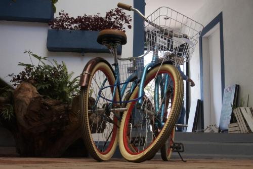 a bike with a basket parked next to a wall at Blue Bicycle House in Querétaro