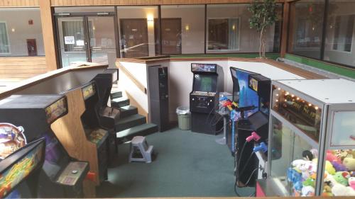 a room with several video games in a building at Woodfield Inn and Suites in Marshfield