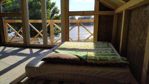 a bed sitting inside of a room with a window at Top Chill party kucice apartmani in Belgrade