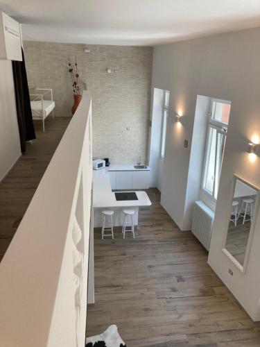 a living room with a staircase and a dining room table at San Giuseppe Suite in Riva del Garda