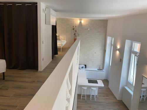 a staircase leading up to a living room and a bathroom at San Giuseppe Suite in Riva del Garda