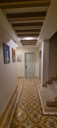 an empty hallway with a door and a tile floor at DAR AMEL in Houmt Souk