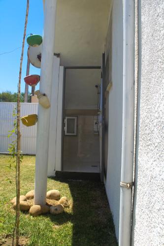 a door to a building with a teddy bear in the grass at Villa Baya in El Haouaria