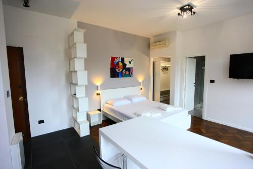 a bedroom with a bed and a television in it at B&B Allegra in Bologna