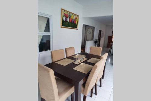a dining room with a table and chairs at Stay@Pitaloka in Cirebon